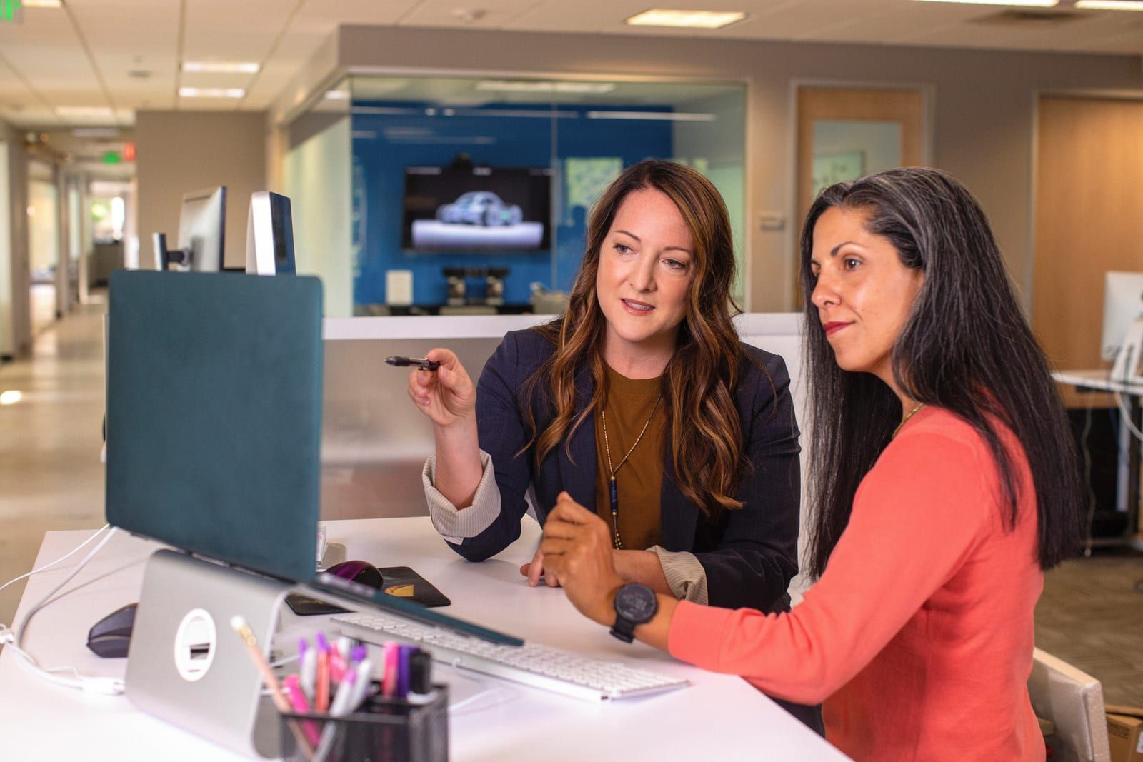 Two colleagues reviewing a screen together